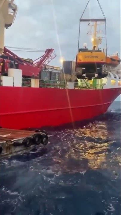 Lifting A Heavy Lift Huge Escavader By Ships Crane In Rough Sea Heavy Weather Safe Lifting