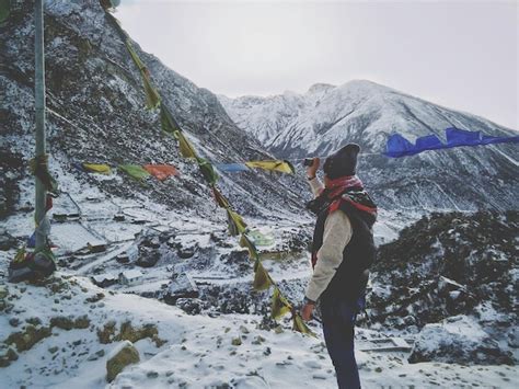 Premium Photo Side View Of Man Standing By Prayer Flags On Snow