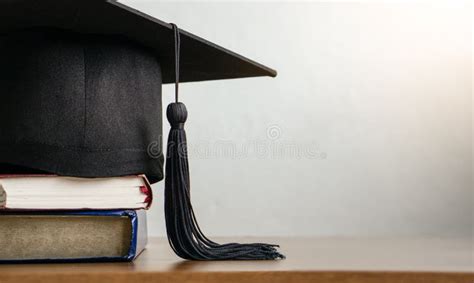 Mortar Board With Degree Paper And Books On Wood Table Stock Image