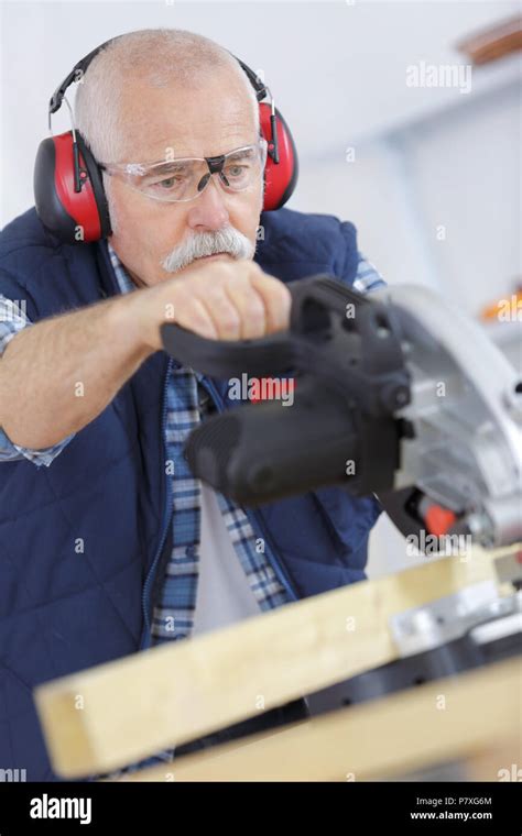 Senior Carpenter Cutting Wooden Plank With Circular Saw Stock Photo Alamy