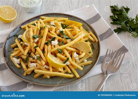 Homemade Greek Fries With Feta And Tzatziki On A Plate Side View Stock