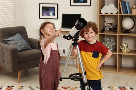 Cute Little Children Using Telescope To Look At Stars In Room Stock ...