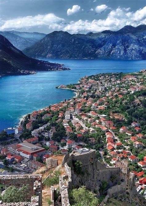 An Aerial View Of A Town And The Ocean With Mountains In The Background