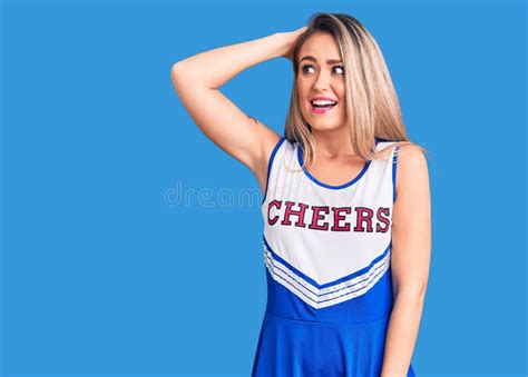 Young Beautiful Blonde Woman Wearing Cheerleader Uniform Smiling