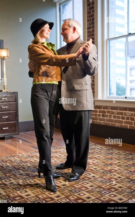 Romantic Middle Aged Couple Dancing In Living Room Stock Photo Alamy