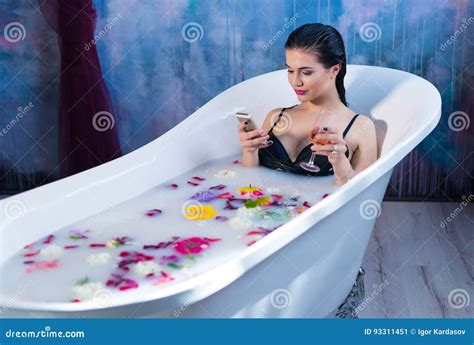 Brunette Woman Is Sitting In Bath And Chatting On Smartphone Stock Image Image Of Bathroom