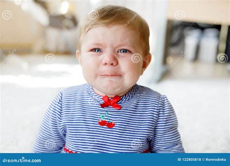 Cute Little Sad Baby Girl Crying Hungry Or Tired Child Sitting Indoors