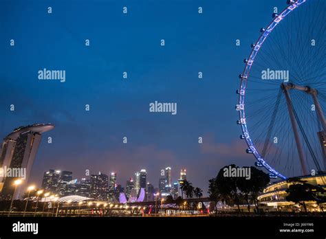 Night time view of Singapore, including the famous Singapore Flyer ...