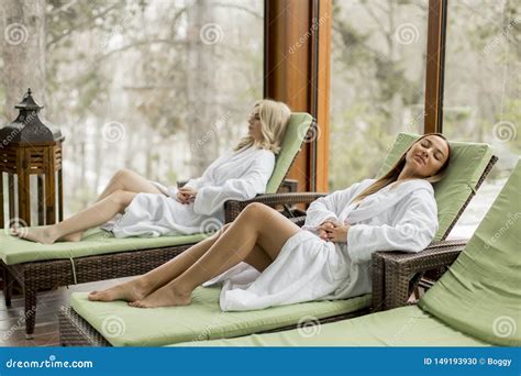 Young Women Relaxing On The Deckchair By The Swimming Pool In Spa Stock