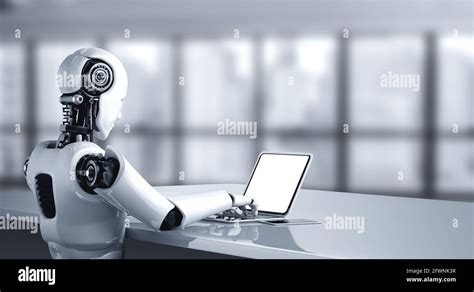 Robot Humanoid Use Laptop And Sit At Table In Future Office While Using