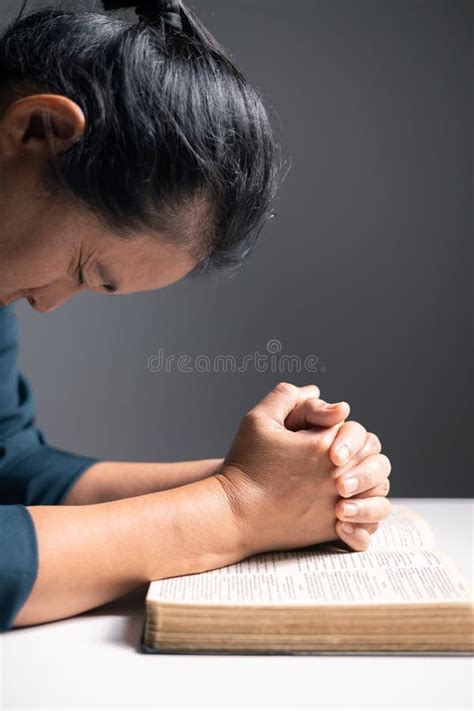 Woman Raises Her Hand In Prayer With Deep Faith In God Worshiping