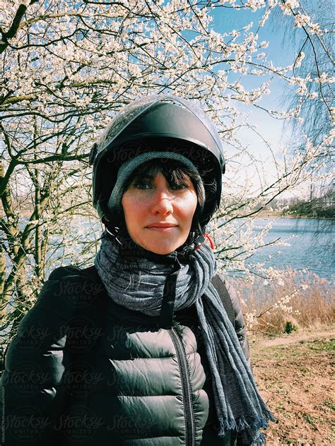 "Outdoor Portrait Of Pretty Woman Wearing Motorbike Helmet" by Stocksy