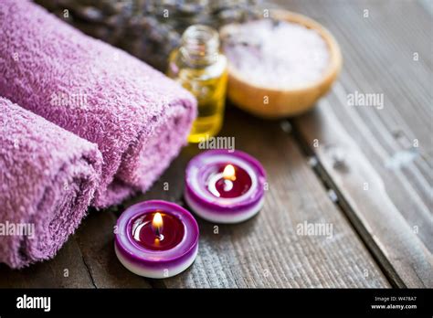 Still Life Setting With Towels And Candles Lavender Spa With Oil Flowers And Scented Candles