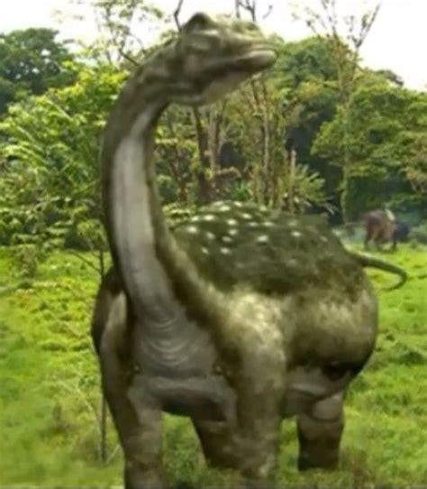 An Image Of A Dinosaur Statue In The Grass