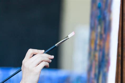 Premium Photo Cropped Hand Of Woman Holding Paintbrush