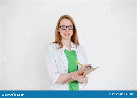 Portrait Of An Attractive Young Female Doctor In White Coat Stock