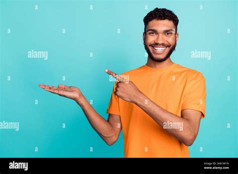 Photo Of Pretty Positive Guy Wear Orange T Shirt Pointing Finger