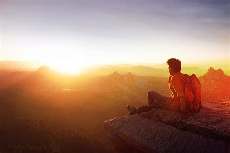 Free Photo Man Sitting On Edge Facing Sunset Adult Mountain Top