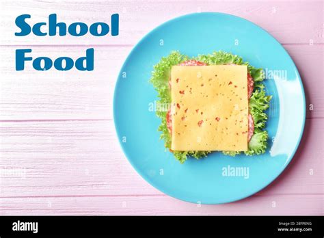 Concept Of School Lunch Plate With Sandwich On Wooden Background Stock