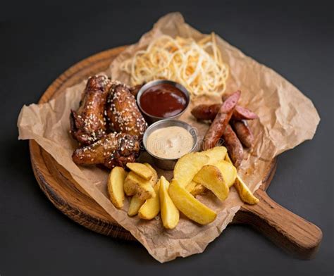 Wide Selection Of Snacks For Beer With Different Sauces On Parchment