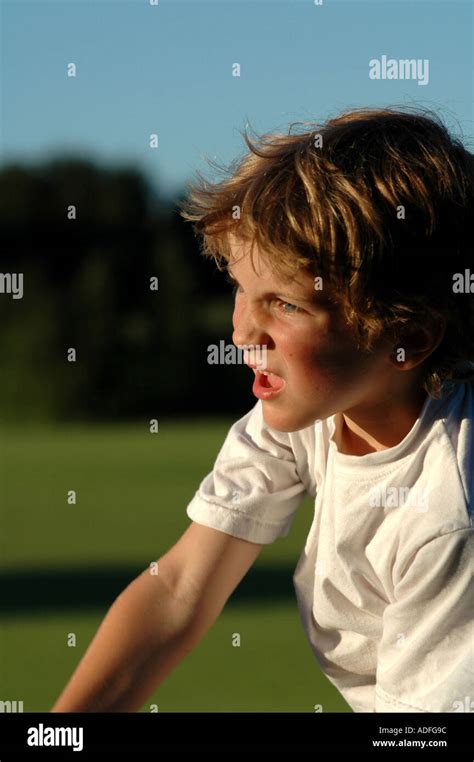 young boy playing sport, bowling in a game of cricket Stock Photo - Alamy