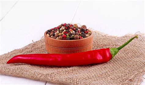 Premium Photo The Red Hot Chili Peppers On Old Wooden Table Surface Texture Background
