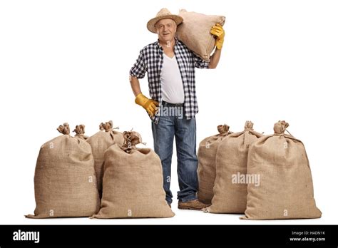 Full Length Portrait Of A Mature Farmer With A Burlap Sack On His