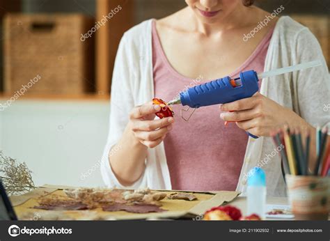 Woman Using Hot Glue Gun While Making Floral Decor Stock Photo By Dragonimages