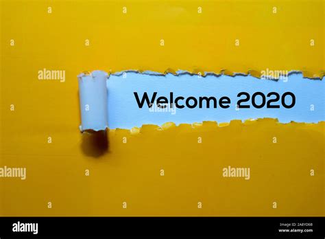 Close Up Welcome 2020 Written In Yellow Torn Paper Stock Photo Alamy