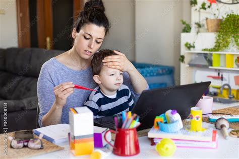 Tele working mother taking care of her sick child Stock Photo | Adobe Stock