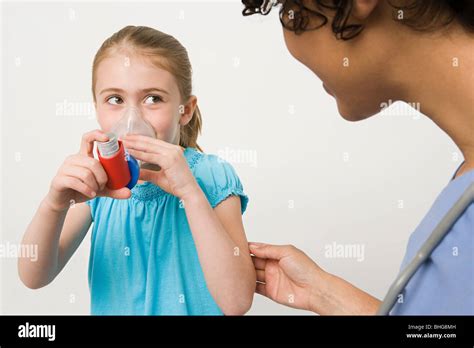 Girl Taking Asthma Inhaler Stock Photo Alamy