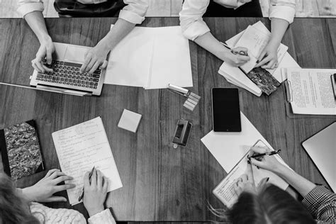 People Writing and a Person Using a Laptop · Free Stock Photo