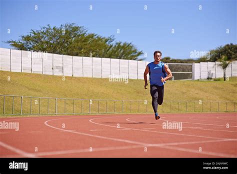 He Belongs On The Track A Young Male Athlete Running On The Track