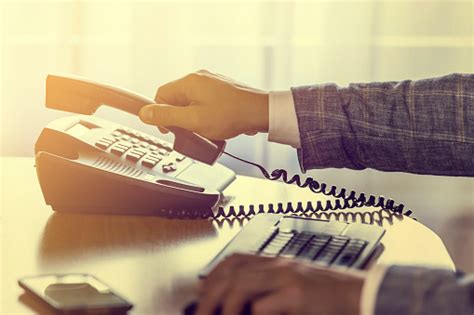 businessman pick   hangs   voip phone stock photo