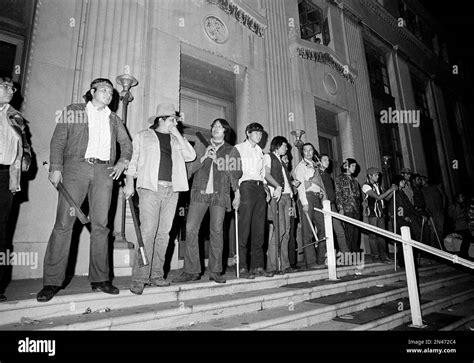 Members Of American Indian Movement Aka AIM Stand Guard With Clubs In