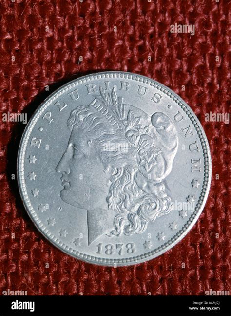 1878 United States Silver Dollar Coin Face Of Liberty E Pluribus Unum On Red Weave Fabric