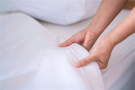 Female Hand Set Up White Bed Sheet In Bedroom Or Maid Hands Making Bed