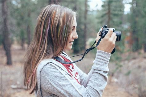 Teen Girl Taking Photos With Her Digital Camera In The Forest By