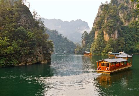 Baofeng Lake Boat Trip In A Rainy Day With Clouds And Mist At