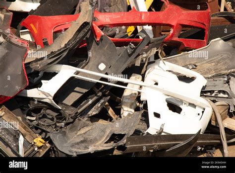 Broken Bumpers And Parts Of Cars On The Street Like Garbage Stock Photo