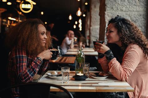 Two Women Talking And Drinking Coffee In A Cafe Jacob Lund