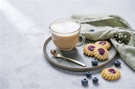 Cappuccino Or Latte With Milk Foam In A Cup With Homemade Berry Cookies