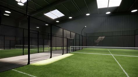 Unused green padel tennis courts inside a warehouse building. Located
