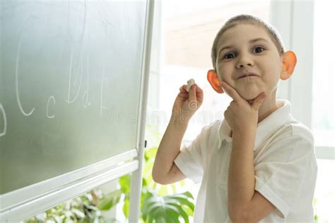 Boy Writing Abc Letters On The Green Chalkboard Stock Image Image Of