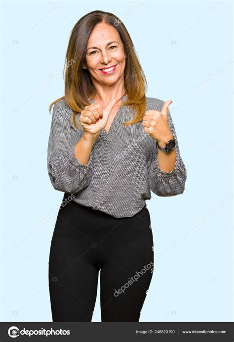 Beautiful Middle Age Business Woman Pointing Back Hand Thumbs Smiling