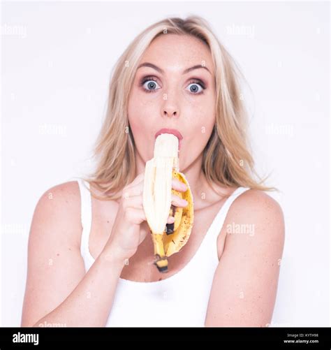 Pretty Blonde Woman Eating A Banana Stock Photo Alamy