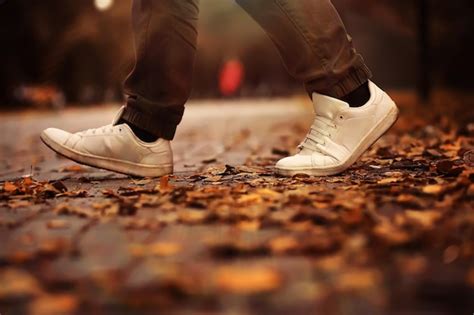 Premium Photo Conceptual Image Of Legs In Boots On The Autumn Leaves