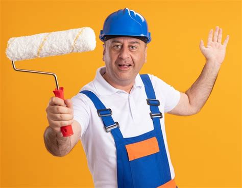 Free Photo Pleased Caucasian Adult Builder Man In Uniform Stands With