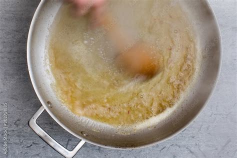 Overhead view of mixing melting butter in saucepan Stock Photo | Adobe ...