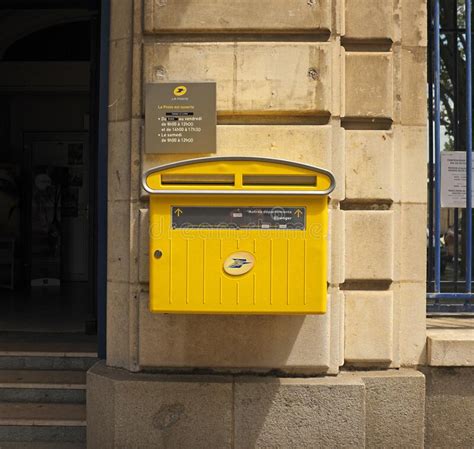 Yellow French Mail Box Fixed To Outside Wall Of A Post Office Editorial